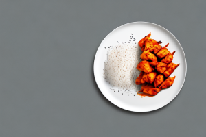 A plate of basmati rice with spicy chicken tikka